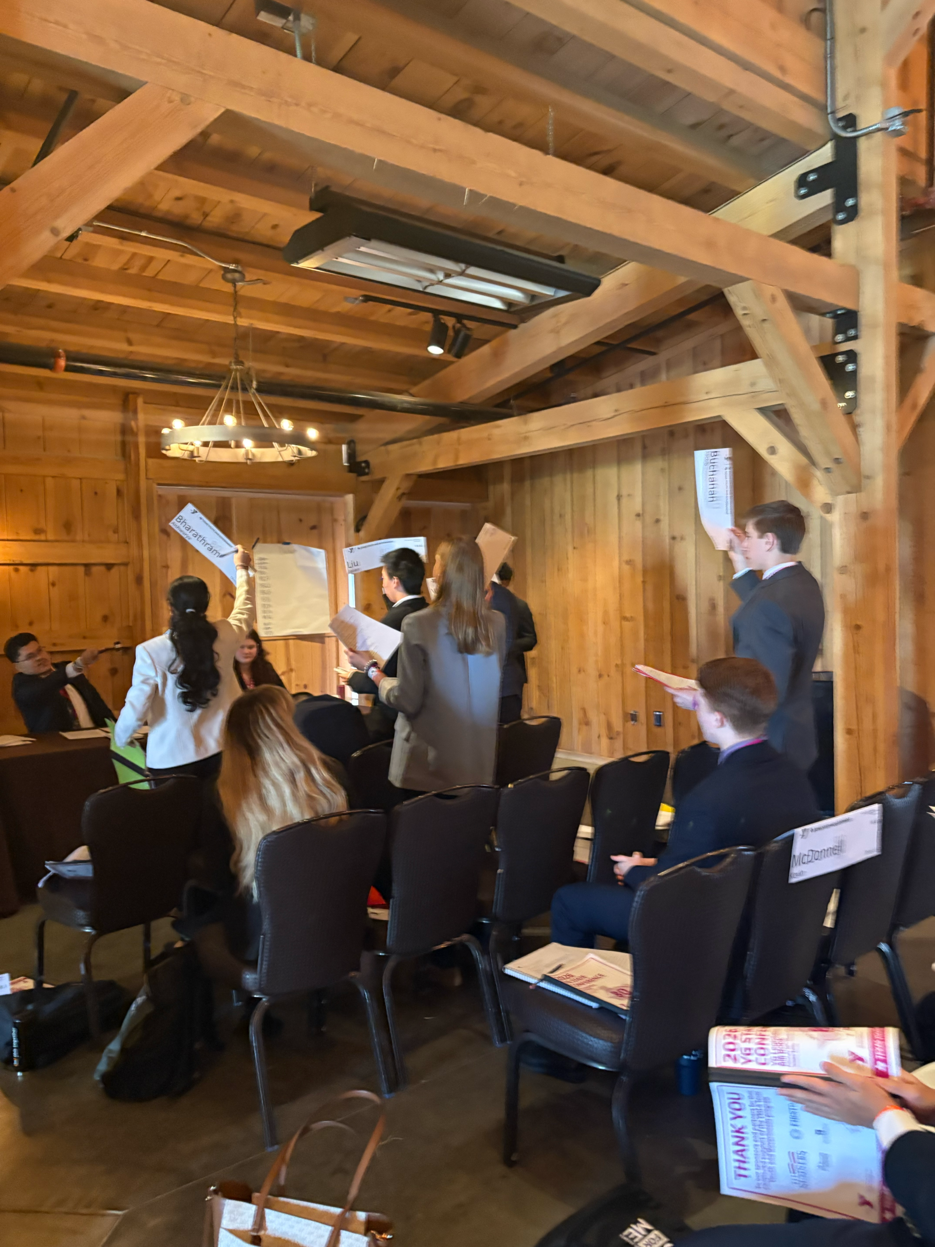 Dorcasowala1blogpost Students in suits raise white papers in a mock senate exercise